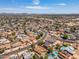 This aerial shot showcases a neighborhood with houses and streets surrounded by mountains in the background at 6015 W Acoma Dr, Glendale, AZ 85306