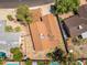 Shot from above, the home's roof is displayed plus the fenced backyard with nearby trees and neighborhood homes at 6015 W Acoma Dr, Glendale, AZ 85306