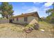 Backyard featuring a detached structure, desert landscaping, and a block wall at 6015 W Acoma Dr, Glendale, AZ 85306