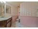 Bathroom featuring sink with vanity, toilet, and floral patterned wallpaper at 6015 W Acoma Dr, Glendale, AZ 85306