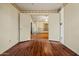 Open bedroom with an entrance to another space and new flooring at 6015 W Acoma Dr, Glendale, AZ 85306