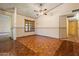 Dining room featuring hardwood floors, a ceiling fan, and views into other rooms at 6015 W Acoma Dr, Glendale, AZ 85306