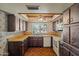 Kitchen view featuring wooden cabinets, countertops, window, and vintage design at 6015 W Acoma Dr, Glendale, AZ 85306