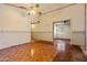 Living room with wood floors, neutral walls, and a ceiling fan at 6015 W Acoma Dr, Glendale, AZ 85306