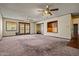 Large living room with a sliding glass door and built-in shelving at 6015 W Acoma Dr, Glendale, AZ 85306
