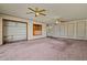 Open-concept living room featuring two ceiling fans and natural light at 6015 W Acoma Dr, Glendale, AZ 85306