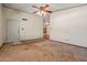 Carpeted living room with a ceiling fan and an entryway to other rooms at 6015 W Acoma Dr, Glendale, AZ 85306