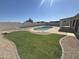 Expansive backyard featuring a sparkling pool, lush lawn, and a stylish patio area at 6029 E Palm St, Mesa, AZ 85215