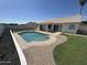 Beautiful backyard with a pristine pool, manicured lawn, and tasteful landscaping at 6029 E Palm St, Mesa, AZ 85215