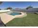 Wide shot of a well-kept backyard showcasing a swimming pool and manicured lawn at 6029 E Palm St, Mesa, AZ 85215
