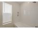 Bright bathroom with subway tile surround, window with light-filtering blinds, and bathtub at 6029 E Palm St, Mesa, AZ 85215