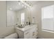 Stylish bathroom featuring quartz countertops, white cabinetry, gold hardware and a modern light fixture at 6029 E Palm St, Mesa, AZ 85215