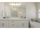 Bathroom vanity with double sinks, quartz countertops, gold hardware and a glimpse of the walk-in shower at 6029 E Palm St, Mesa, AZ 85215