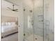 Bright bathroom showcasing a frameless glass shower with gold hardware and a view into the primary bedroom at 6029 E Palm St, Mesa, AZ 85215