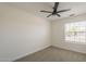 Neutral bedroom with carpet, ceiling fan, and a window offering natural light at 6029 E Palm St, Mesa, AZ 85215
