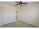 Comfortable bedroom with neutral carpet, closet with sliding doors, and white trim at 6029 E Palm St, Mesa, AZ 85215