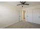 Neutral bedroom with carpet, ceiling fan, closet, and a window offering natural light at 6029 E Palm St, Mesa, AZ 85215