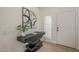 Modern entryway with floating console table, decorative art, and bright natural light at 6029 E Palm St, Mesa, AZ 85215