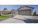 Charming single-story home with a well-manicured lawn, two car garage, and desert landscaping at 6029 E Palm St, Mesa, AZ 85215
