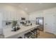 Modern kitchen with white cabinetry, stainless steel appliances, quartz countertops, and breakfast bar seating at 6029 E Palm St, Mesa, AZ 85215