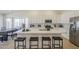 Modern kitchen with white cabinetry, stainless steel appliances, quartz countertops, and breakfast bar seating at 6029 E Palm St, Mesa, AZ 85215