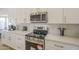 Kitchen detail showcasing stainless steel appliances, quartz countertop, and bright lighting at 6029 E Palm St, Mesa, AZ 85215