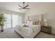 Elegant primary bedroom featuring a plush headboard, soft carpet, and lots of natural light at 6029 E Palm St, Mesa, AZ 85215