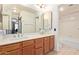 Bathroom featuring double sinks, tile flooring, and a bathtub with a shower at 609 E Mesquite Cir # D133, Tempe, AZ 85288