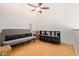 Comfortable bedroom with hardwood floors, a futon couch, a ceiling fan, and ample storage space at 609 E Mesquite Cir # D133, Tempe, AZ 85288