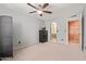 Spacious bedroom featuring a ceiling fan, carpet floors, and access to the bathroom at 609 E Mesquite Cir # D133, Tempe, AZ 85288