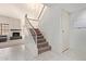 Inviting hallway with tile flooring leading to a carpeted staircase and an open living area at 609 E Mesquite Cir # D133, Tempe, AZ 85288