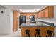 Efficient kitchen layout with a breakfast bar, overhead skylight, and essential black appliances at 609 E Mesquite Cir # D133, Tempe, AZ 85288