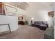 Open-concept living space with soaring ceilings, fireplace, and a loft overlooking the downstairs area at 609 E Mesquite Cir # D133, Tempe, AZ 85288
