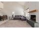 Spacious living area with a fireplace, vaulted ceilings, and a sectional sofa for comfortable living at 609 E Mesquite Cir # D133, Tempe, AZ 85288