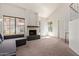 Bright living room with a fireplace, large windows, and vaulted ceiling at 609 E Mesquite Cir # D133, Tempe, AZ 85288