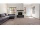 Sun-filled living room showcasing a cozy fireplace, neutral carpet, and a comfortable gray sectional sofa at 609 E Mesquite Cir # D133, Tempe, AZ 85288