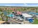 Resort-style living: aerial view showcasing a community pool, tennis courts, and lush landscapes at 6461 S Oakmont Dr, Chandler, AZ 85249