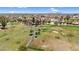 Expansive aerial view of a community with a golf course and scenic mountain backdrop on a sunny day at 6461 S Oakmont Dr, Chandler, AZ 85249