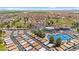 Aerial view of a golf course and blue tennis courts surrounded by residential properties and scenic landscapes at 6461 S Oakmont Dr, Chandler, AZ 85249