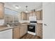 Well-lit kitchen boasts wood floors, stainless sink, and a white microwave at 6461 S Oakmont Dr, Chandler, AZ 85249