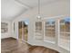 Bright living room with wood flooring, recessed lights, large windows, and sliding door at 6461 S Oakmont Dr, Chandler, AZ 85249