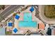 Aerial view of a T-shaped pool featuring lounge chairs and blue canopies perfect for relaxing in the sun at 6461 S Oakmont Dr, Chandler, AZ 85249