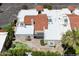 Aerial view of the property highlighting the roof, backyard patio, lush landscaping and proximity to trees at 7319 E Rose Ln, Scottsdale, AZ 85250