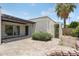 Inviting back patio with shaded pergola, brick pavers, and lush greenery creating a relaxing outdoor space at 7319 E Rose Ln, Scottsdale, AZ 85250