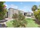 Lush backyard featuring a well-maintained lawn, mature trees, and a charming patio area perfect for outdoor enjoyment at 7319 E Rose Ln, Scottsdale, AZ 85250