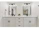 Bathroom with modern double vanity, mirrors and lighting fixtures at 7319 E Rose Ln, Scottsdale, AZ 85250