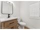 Bright bathroom featuring a wood vanity and neutral finishes at 7319 E Rose Ln, Scottsdale, AZ 85250