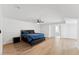 Spacious bedroom with wood floors, ceiling fan, large bed and ensuite bathroom at 7319 E Rose Ln, Scottsdale, AZ 85250