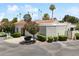 Inviting front exterior featuring a well-manicured lawn, mature landscaping, and a welcoming facade at 7319 E Rose Ln, Scottsdale, AZ 85250