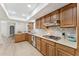 Open kitchen with wooden cabinets, stone countertops and stainless steel appliances at 7319 E Rose Ln, Scottsdale, AZ 85250
